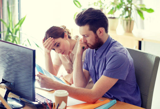 business team with computer and files in office